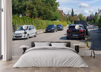 Cars parked on the roadway near private houses. Wall mural