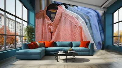 Men's shirts on a hanger in a clothing store in a shopping mall. Wall mural