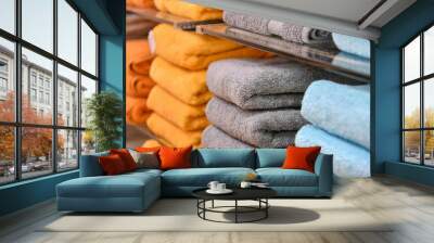 Shower towels of different colors are stacked on the counter of the store. Wall mural