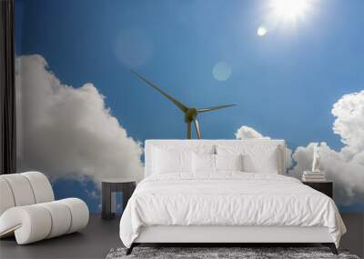 Wind power generator against a cloudy sky. Wall mural