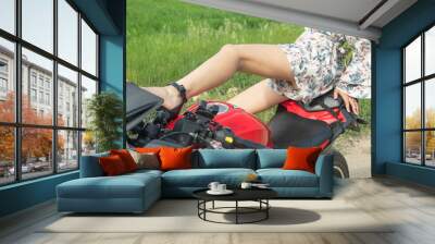 Caucasian young girl in a motorcycle at the nature. Wall mural