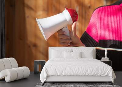 Caucasian young woman holding megaphone. Wall mural