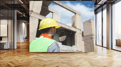 Construction worker with helmet in outdoors. Wall mural