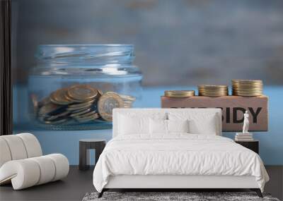 Glass jar of coins with a word Subsidy on wooden block. Wall mural