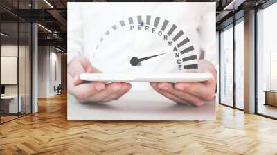 Man holding Performance speedometer. Business concept Wall mural