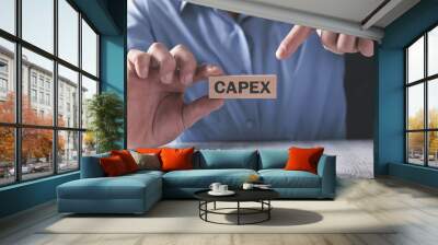 Man showing Capex word on the wooden block. Wall mural