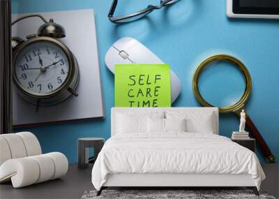 Self care time on sticky note with a clock and business objects. Wall mural