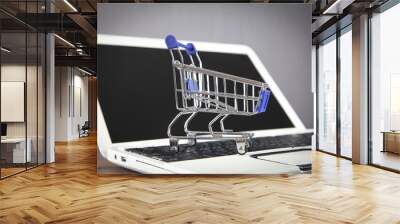 Shopping cart on the laptop keyboard. Wall mural