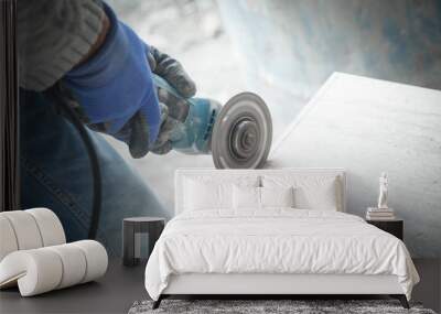 Worker cutting a tile with a grinder. Wall mural