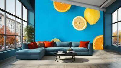 Lemons and Limes on blue background Wall mural