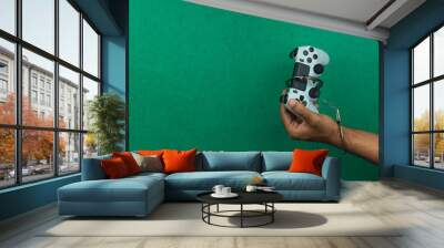 Video game joystick and handcuffs isolated. Addiction to games concept image. Wall mural