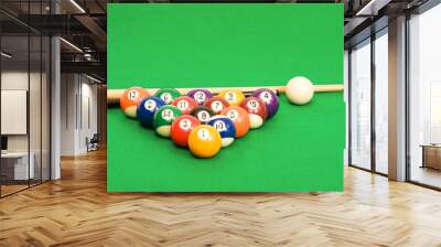 billiard balls arranged on a green material covered pool table Wall mural