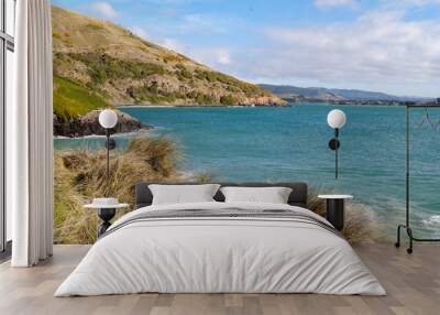 Blue sea with coastal grass and hills (2) Wall mural