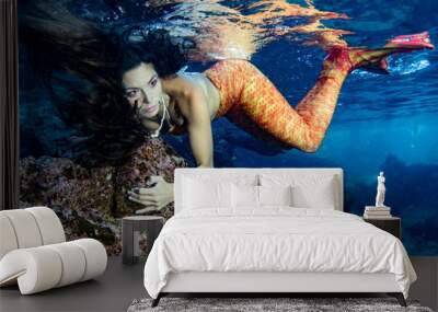 Mermaid swimming underwater in the deep blue sea Wall mural