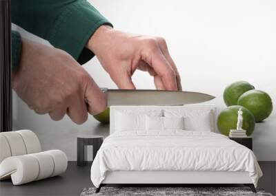 man's hands with a knife cut lime fruit on a marble table with copy space for your text Wall mural