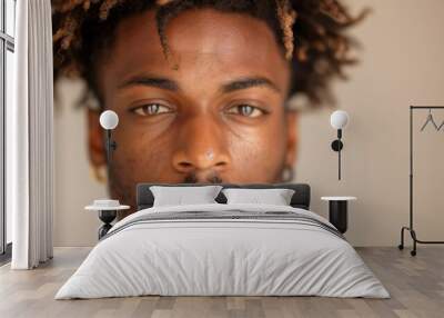 Close up of a young black man with dreadlocks and a neutral expression on his face Wall mural