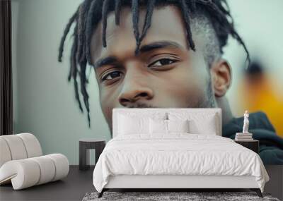 Confident young black man with dreadlocks and beard in urban setting, showcasing trendy style Wall mural