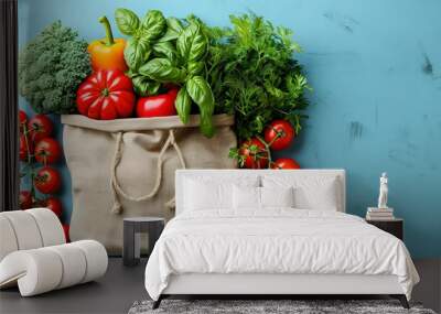 Fresh vegetables arranged on a blue background, promoting healthy eating and sustainable living with reusable packaging Wall mural