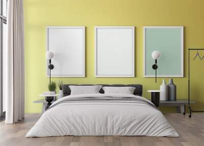 Three empty square frames on a wall. Pastel colours yellow and green. Gallery of frames. Mockup of empty framed poste. Copy space for advertising, sale of artwork, display of photographs, templates. Wall mural