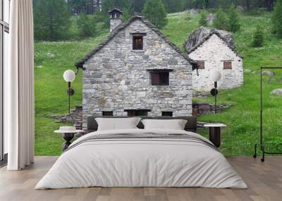 mountain house in the mountain pasture in the Italian and Swiss Alps with stone walls and wooden beams, typical high altitude mountain house Wall mural