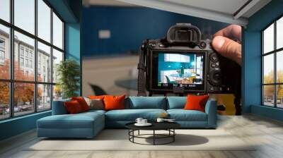 Photographer man taking pictures and video in apartment - real estate home photoshoot for selling house whit professional estate agency - home staging and enhance the property for advertising Wall mural