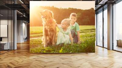 Adorable brother and daughter playing with pet dog Wall mural