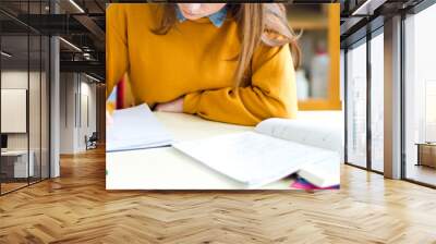 Young female college student in chemistry class, writing notes. Focused student in classroom. Authentic Education concept. Wall mural