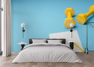 Two yellow dumbbells on a blue background with sheet of paper, new me concept Wall mural