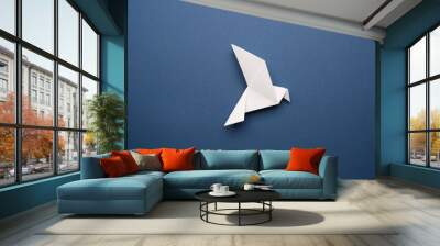 White origami pigeon on a blue paper background, peace or freedom concept Wall mural