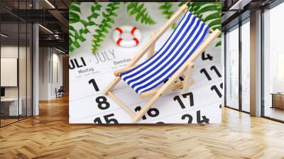 German monthly calendar shows the month of July with deck chair and tropical plants on background, concept of planning summer vacation Wall mural