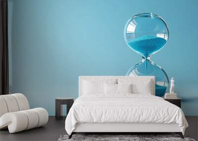 Hourglass showing time on a blue background. Wall mural