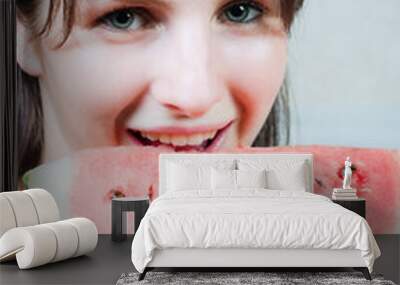 Young woman eating a slice of watermelon Wall mural