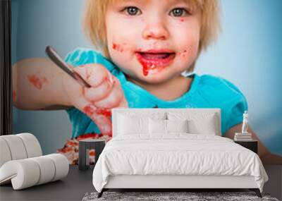 Little baby girl eating cake Wall mural