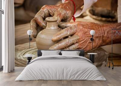 Potter at work makes ceramic dishes. India, Rajasthan. Wall mural