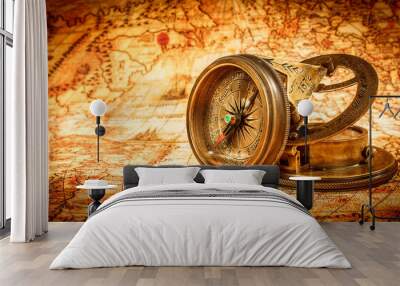 Vintage compass lies on an ancient world map. Wall mural