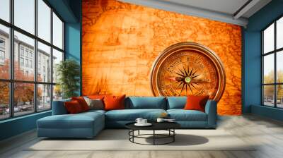 Vintage compass lies on an ancient world map. Wall mural