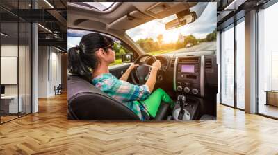 Woman behind the wheel of a car. Wall mural