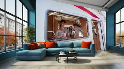 Woman cooking in camper, motorhome interior Wall mural