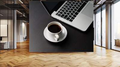 Cup of coffee on the table and laptop computer. Top view. Wall mural