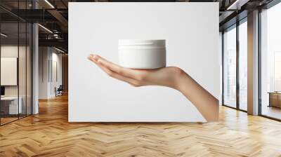 Womans hand holding white cream jar mockup beauty product packaging design isolated on white. Cosmetics isolated on white. Photo realistic photo.
 Wall mural