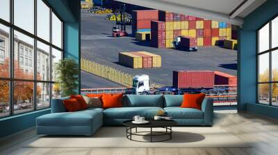 A truck transports a container in a storage area of a cargo sea port Wall mural