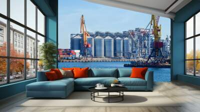 Lifting harbor cranes, shipping containers and granaries in the cargo seaport Wall mural