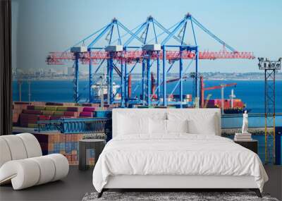 Port cargo crane loads a container onto a cargo ship Wall mural