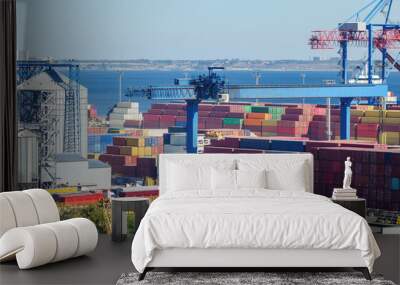 Port cargo crane loads a container onto a cargo ship Wall mural