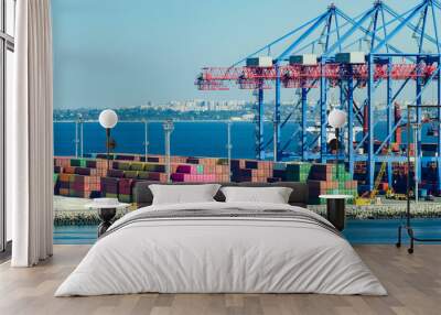 Port cargo crane loads a container onto a cargo ship Wall mural