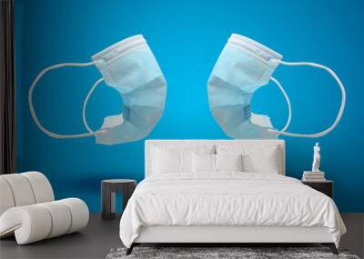 Two Medical masks on blue background Wall mural