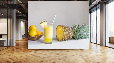 pineapple juice with pineapple in backround Wall mural