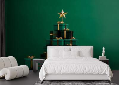 Christmas tree made of gift boxes with golden bows on green background Wall mural