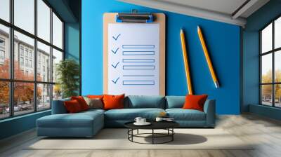 Clipboard showing a checklist with pencils on a blue background Wall mural