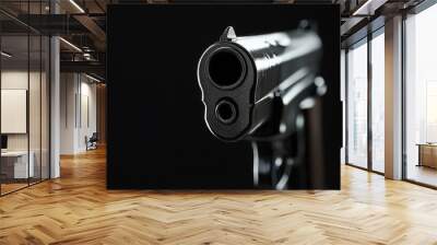 Close up of handgun barrel pointing at viewer on black background Wall mural